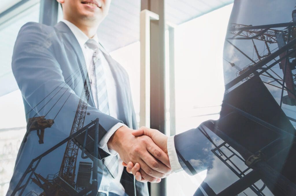 Double Exposure of Two Businessmen Shaking Hand